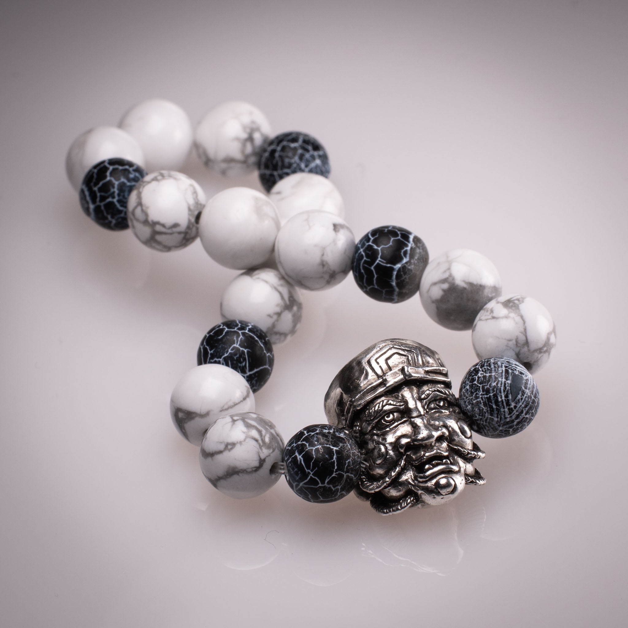 Handcrafted 925 silver Daikokuten charm on an 8mm natural stone bead bracelet, featuring exclusive tattoo art by David Saez for KaijuLab.