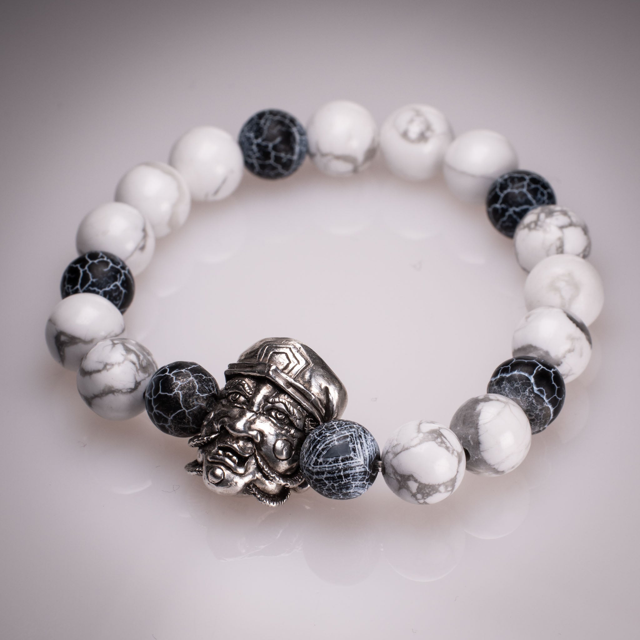 Handcrafted 925 silver Daikokuten charm on an 8mm natural stone bead bracelet, featuring exclusive tattoo art by David Saez for KaijuLab.