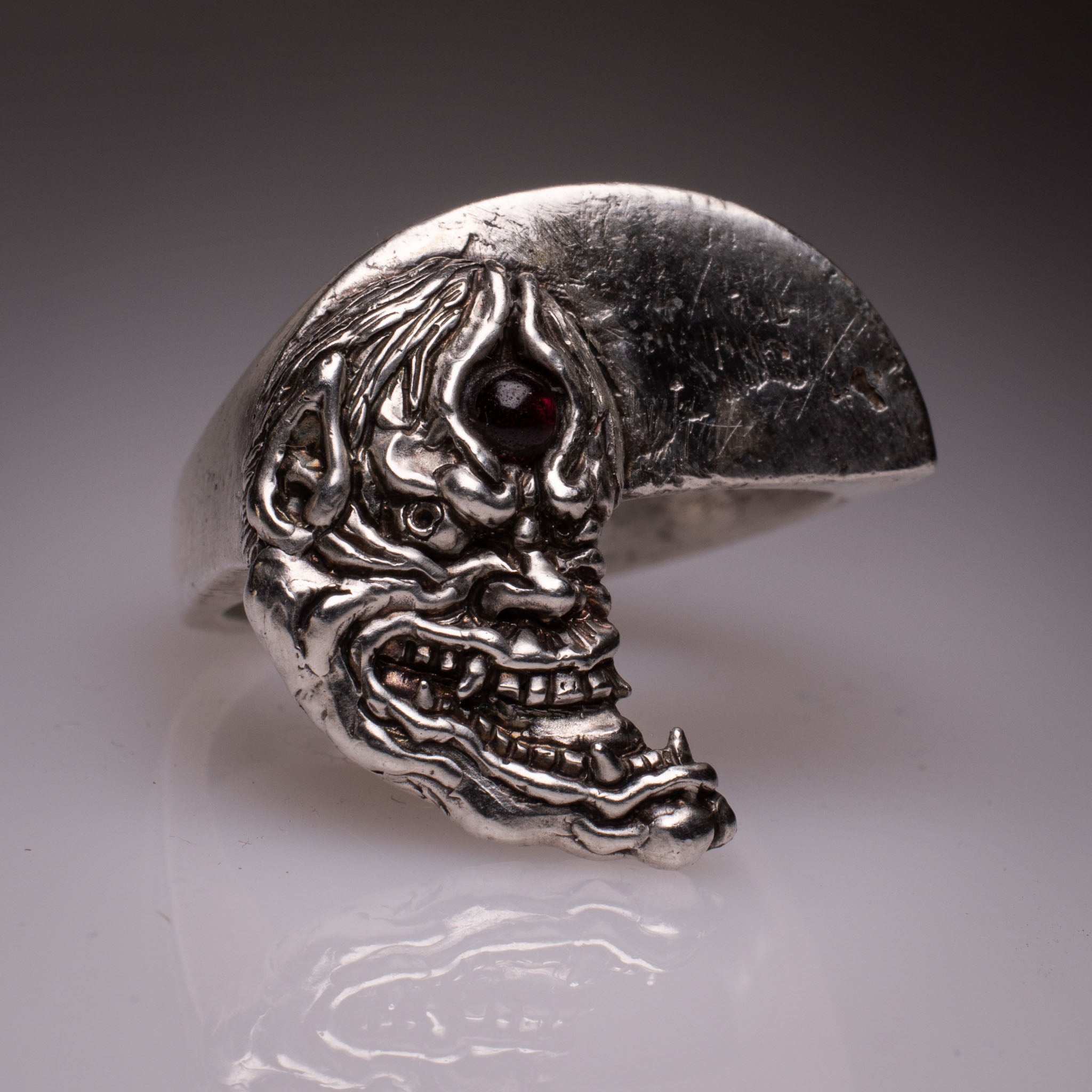 Two 925 silver rings forming a Hannya mask when joined, showing the Yin Yang interlocking design and red stone detail, handcrafted by KaijuLab.