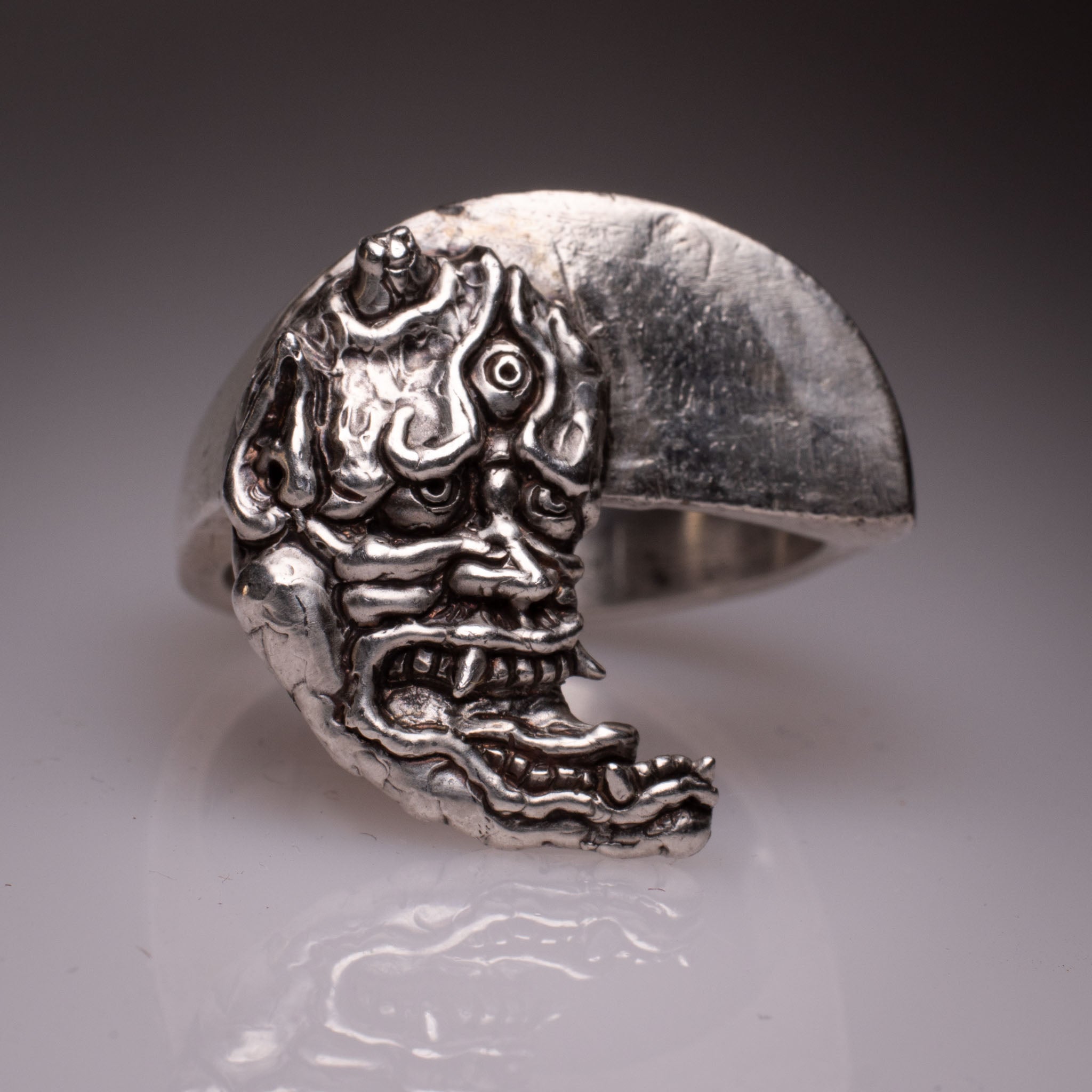 Two 925 silver rings forming a Hannya mask when joined, showing the Yin Yang interlocking design and red stone detail, handcrafted by KaijuLab.