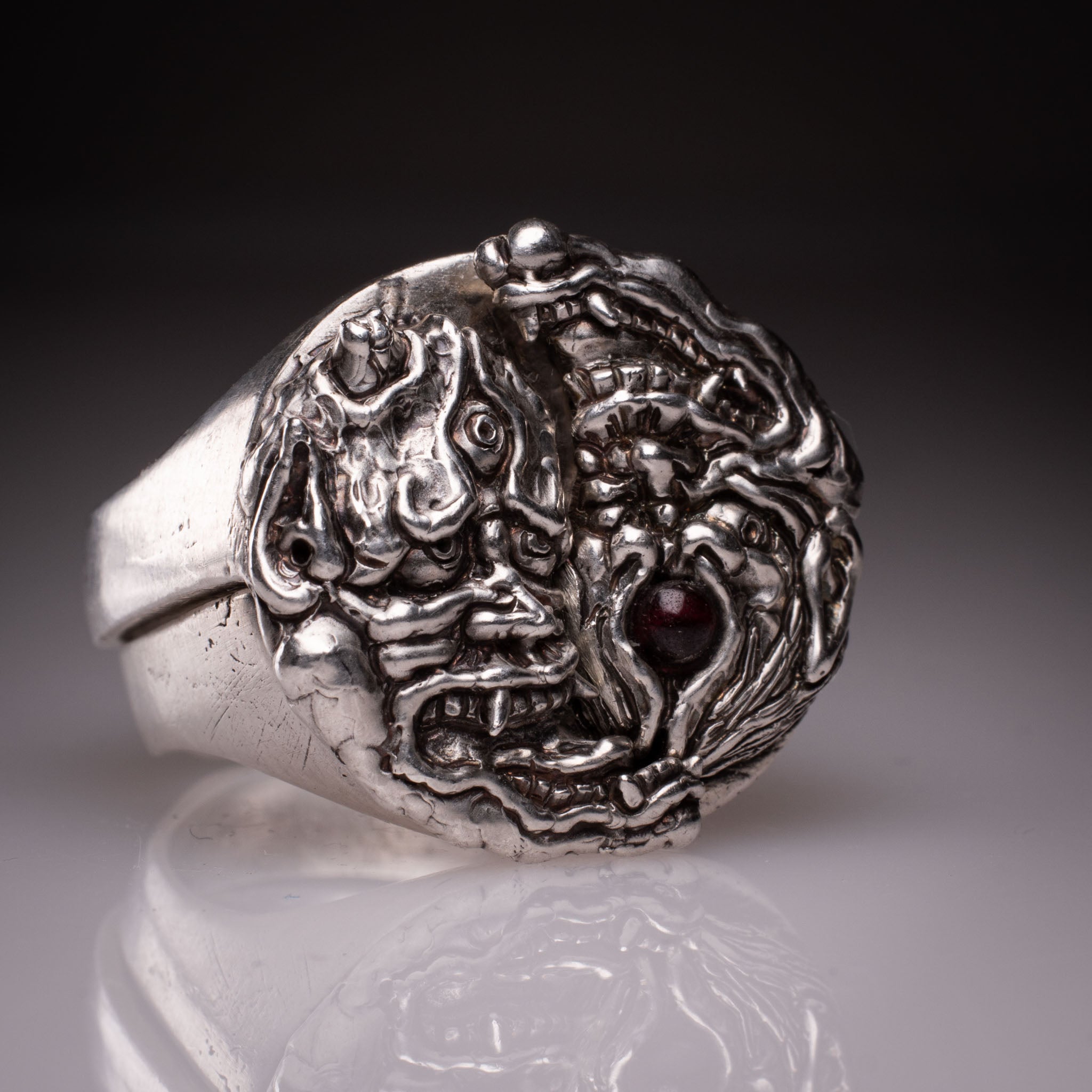 Two 925 silver rings forming a Hannya mask when joined, showing the Yin Yang interlocking design and red stone detail, handcrafted by KaijuLab.
