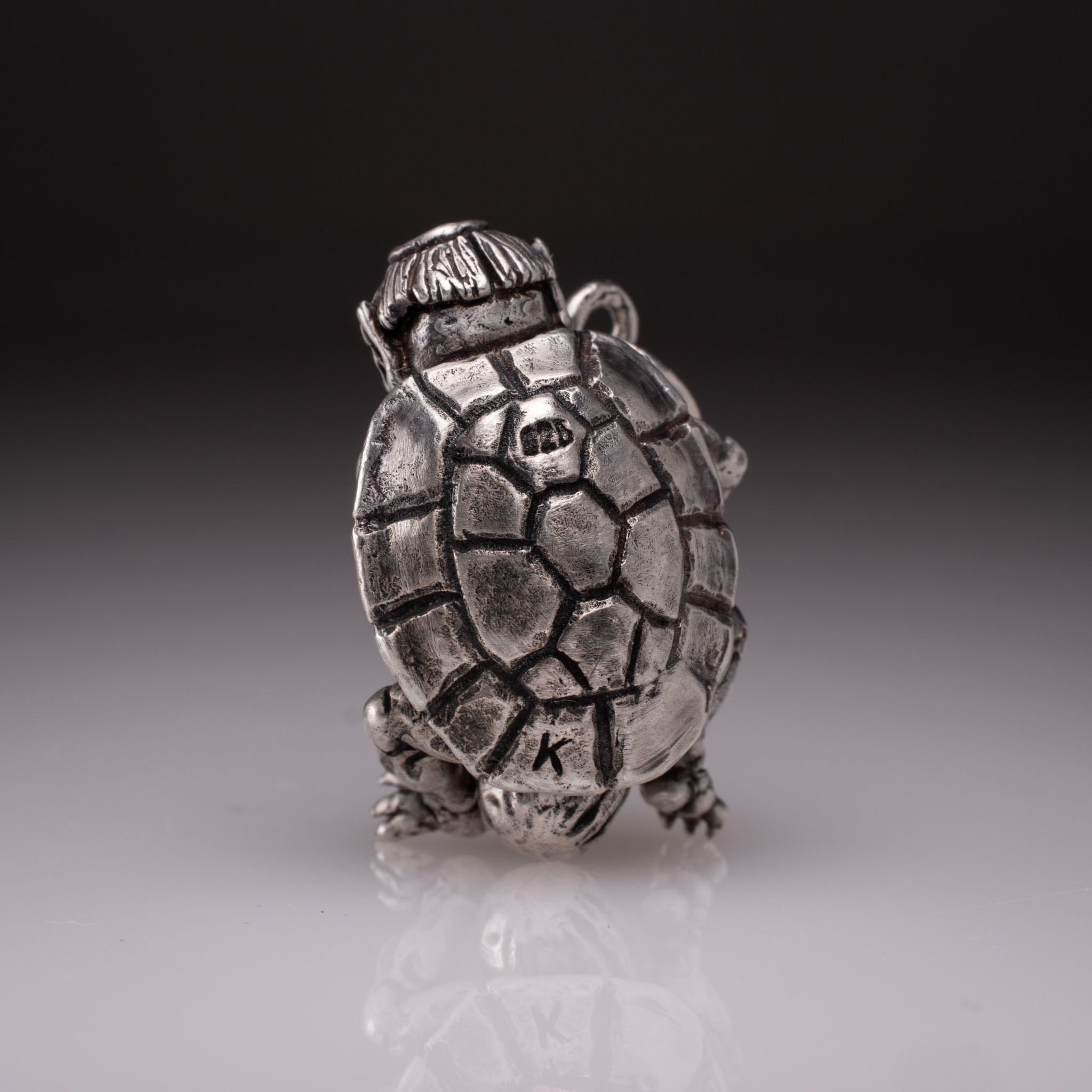 Handcrafted 925 silver full-body Kappa Yokai pendant hugging a cucumber, featuring detailed shell and tattoo art style by David Saez for KaijuLab.