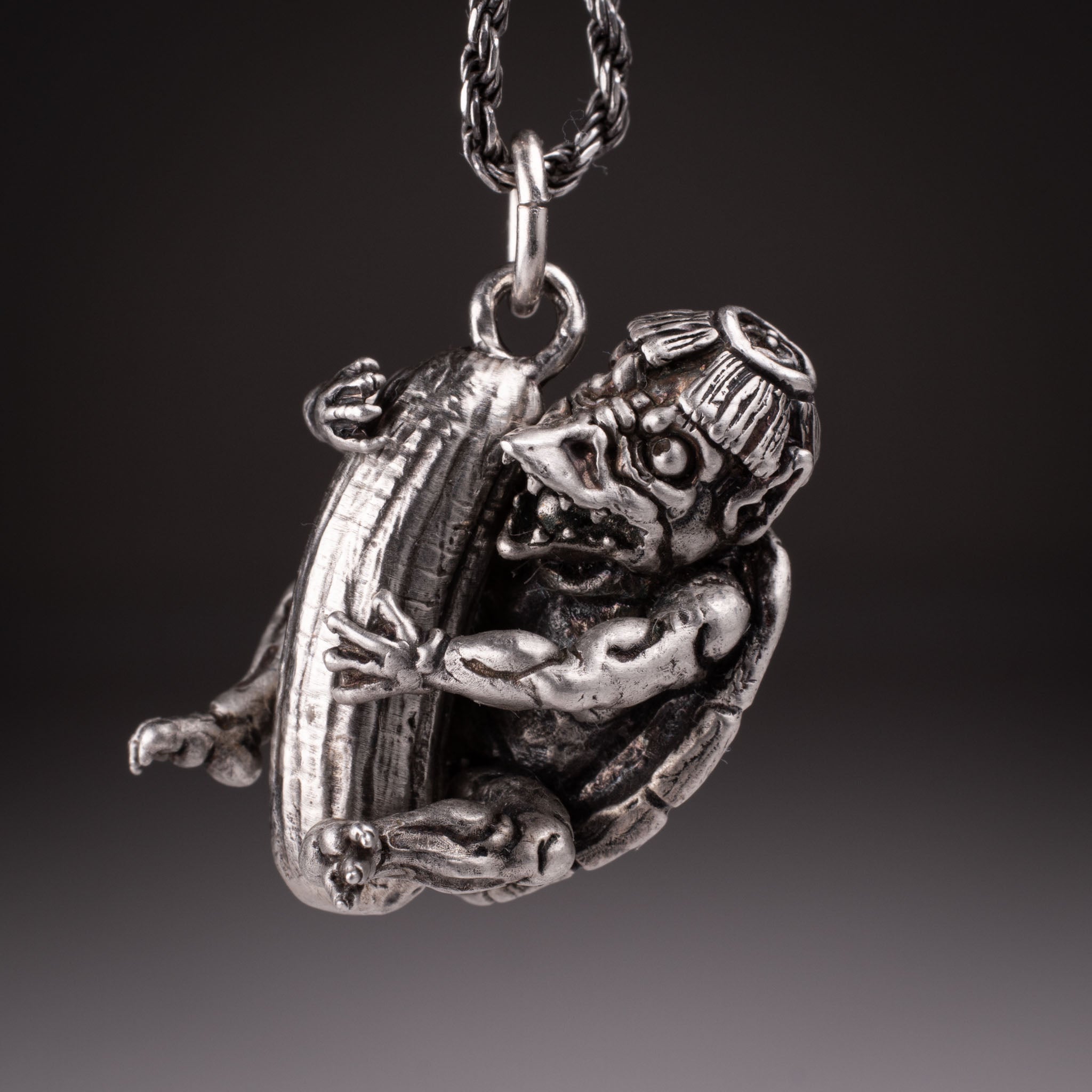 Handcrafted 925 silver full-body Kappa Yokai pendant hugging a cucumber, featuring detailed shell and tattoo art style by David Saez for KaijuLab.