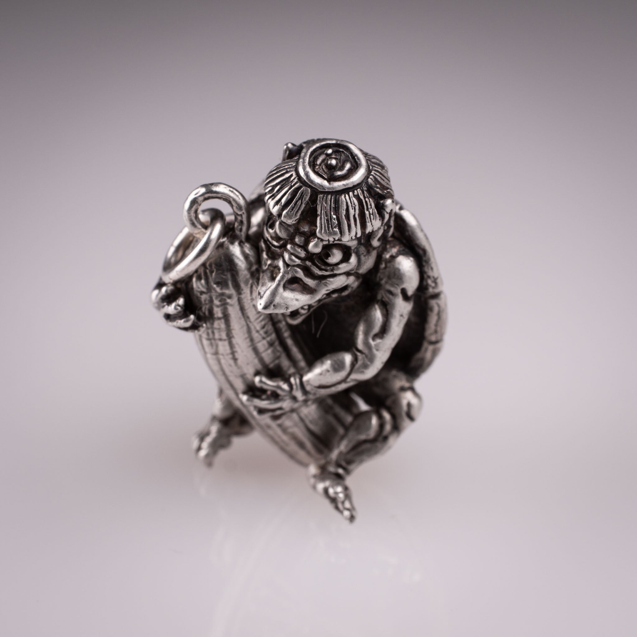 Handcrafted 925 silver full-body Kappa Yokai pendant hugging a cucumber, featuring detailed shell and tattoo art style by David Saez for KaijuLab.