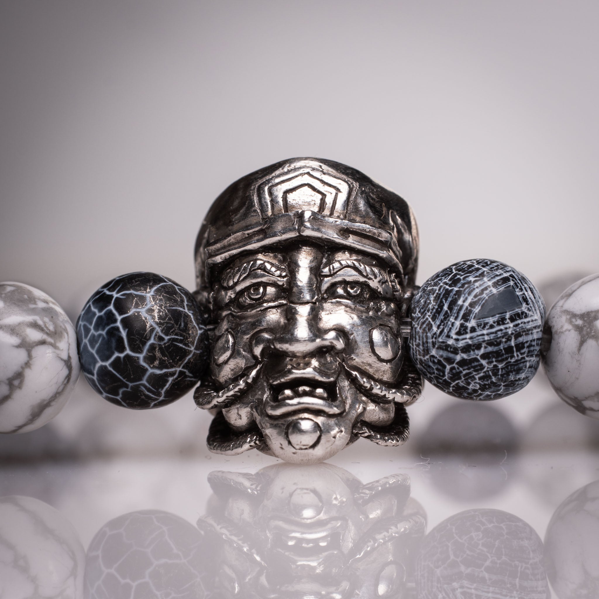 Handcrafted 925 silver Daikokuten charm on an 8mm natural stone bead bracelet, featuring exclusive tattoo art by David Saez for KaijuLab.