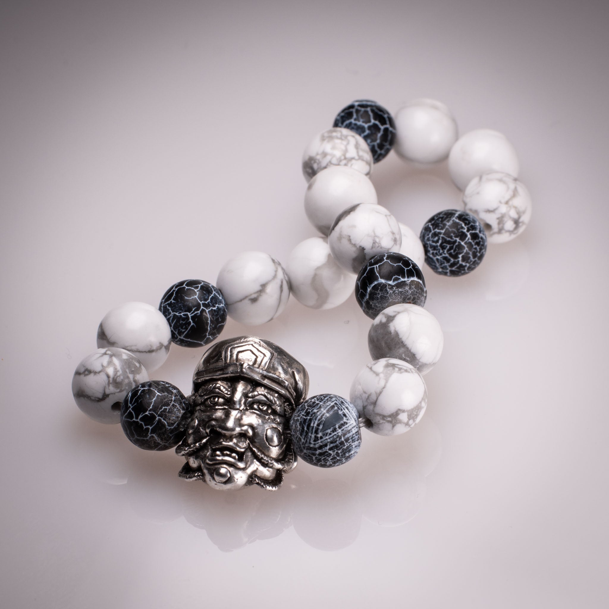 Handcrafted 925 silver Daikokuten charm on an 8mm natural stone bead bracelet, featuring exclusive tattoo art by David Saez for KaijuLab.