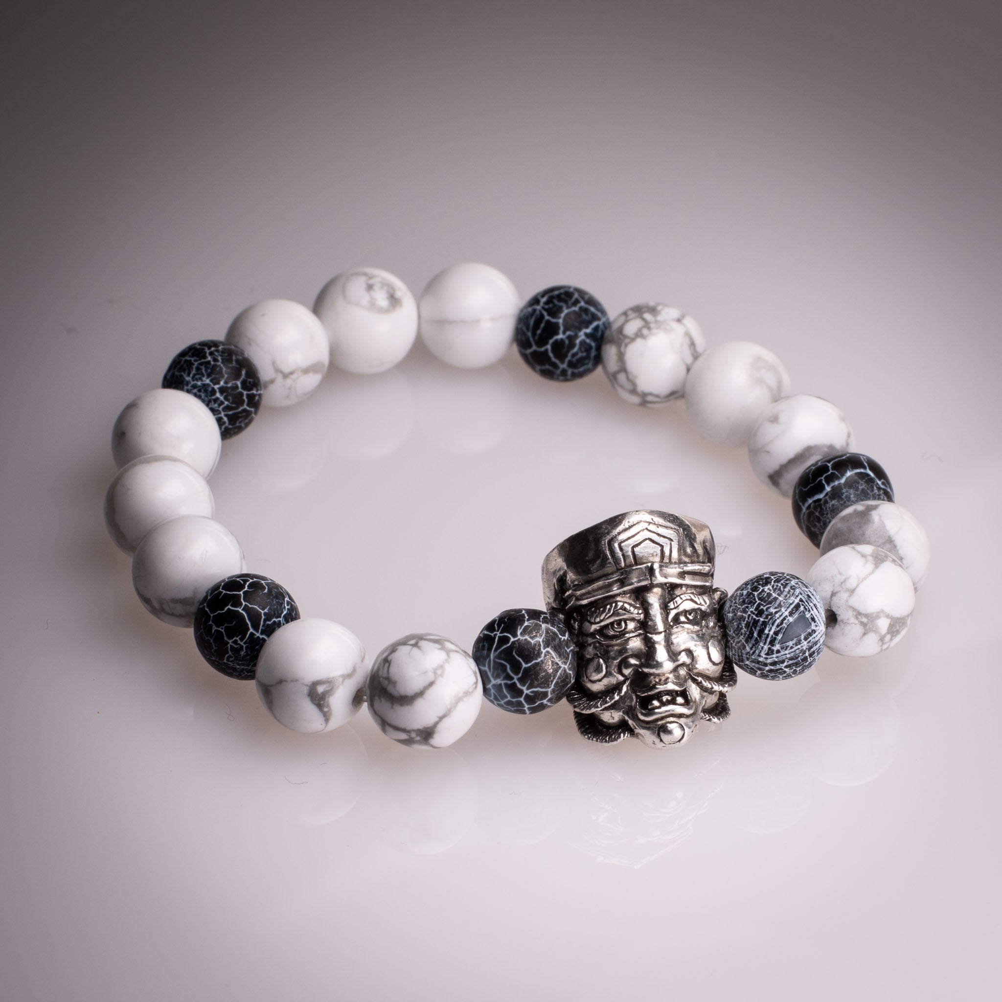 Handcrafted 925 silver Daikokuten charm on an 8mm natural stone bead bracelet, featuring exclusive tattoo art by David Saez for KaijuLab.