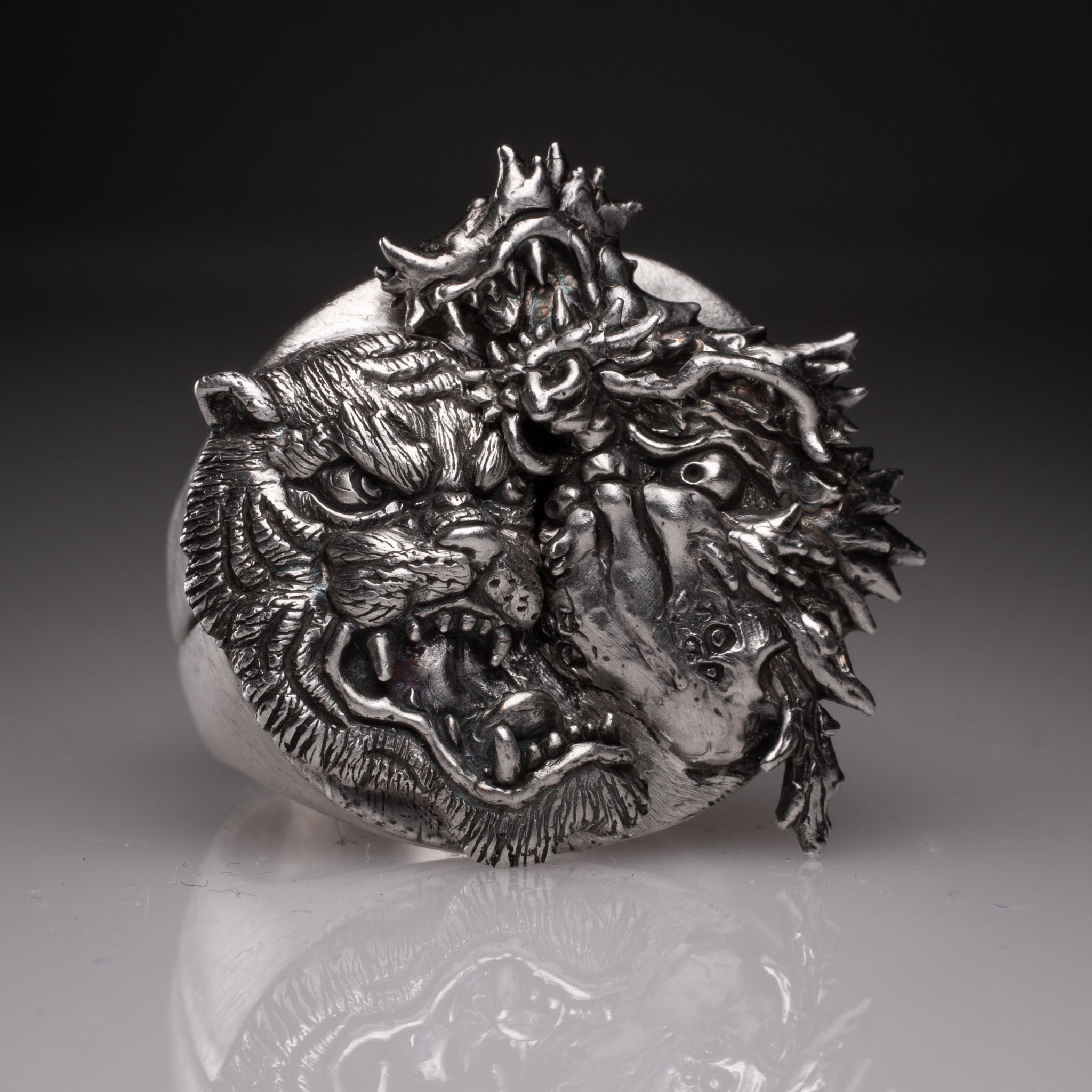 Two 925 silver rings forming a Yin Yang circle when joined, featuring detailed faces of a Dragon and a Tiger, handcrafted by KaijuLab.