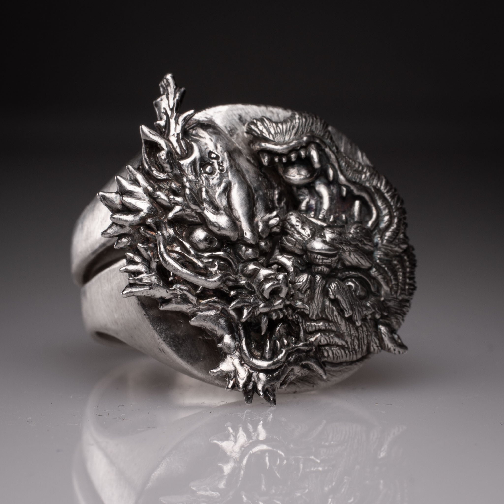 Two 925 silver rings forming a Yin Yang circle when joined, featuring detailed faces of a Dragon and a Tiger, handcrafted by KaijuLab.