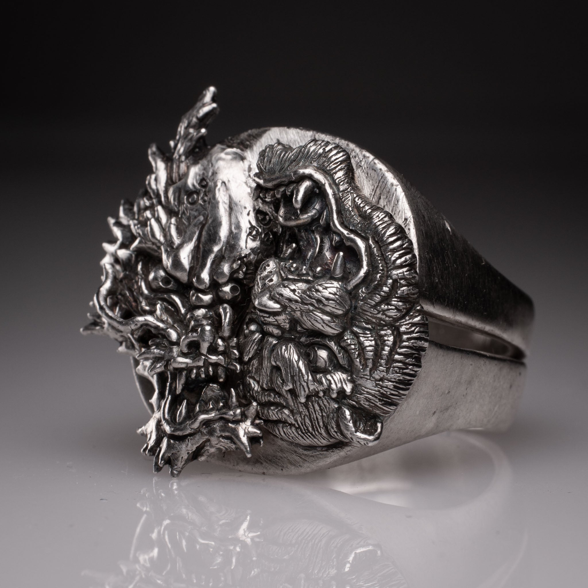 Two 925 silver rings forming a Yin Yang circle when joined, featuring detailed faces of a Dragon and a Tiger, handcrafted by KaijuLab.
