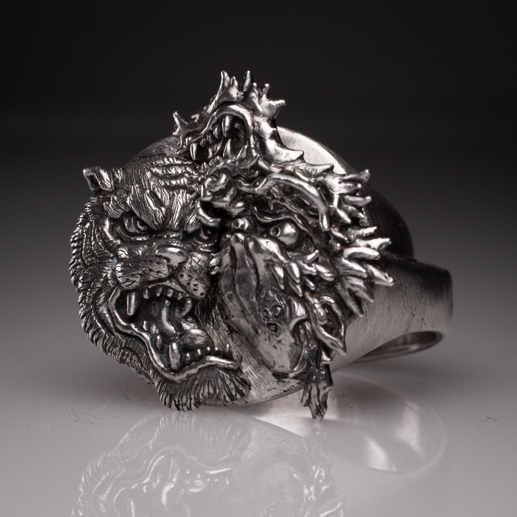 Two 925 silver rings forming a Yin Yang circle when joined, featuring detailed faces of a Dragon and a Tiger, handcrafted by KaijuLab.