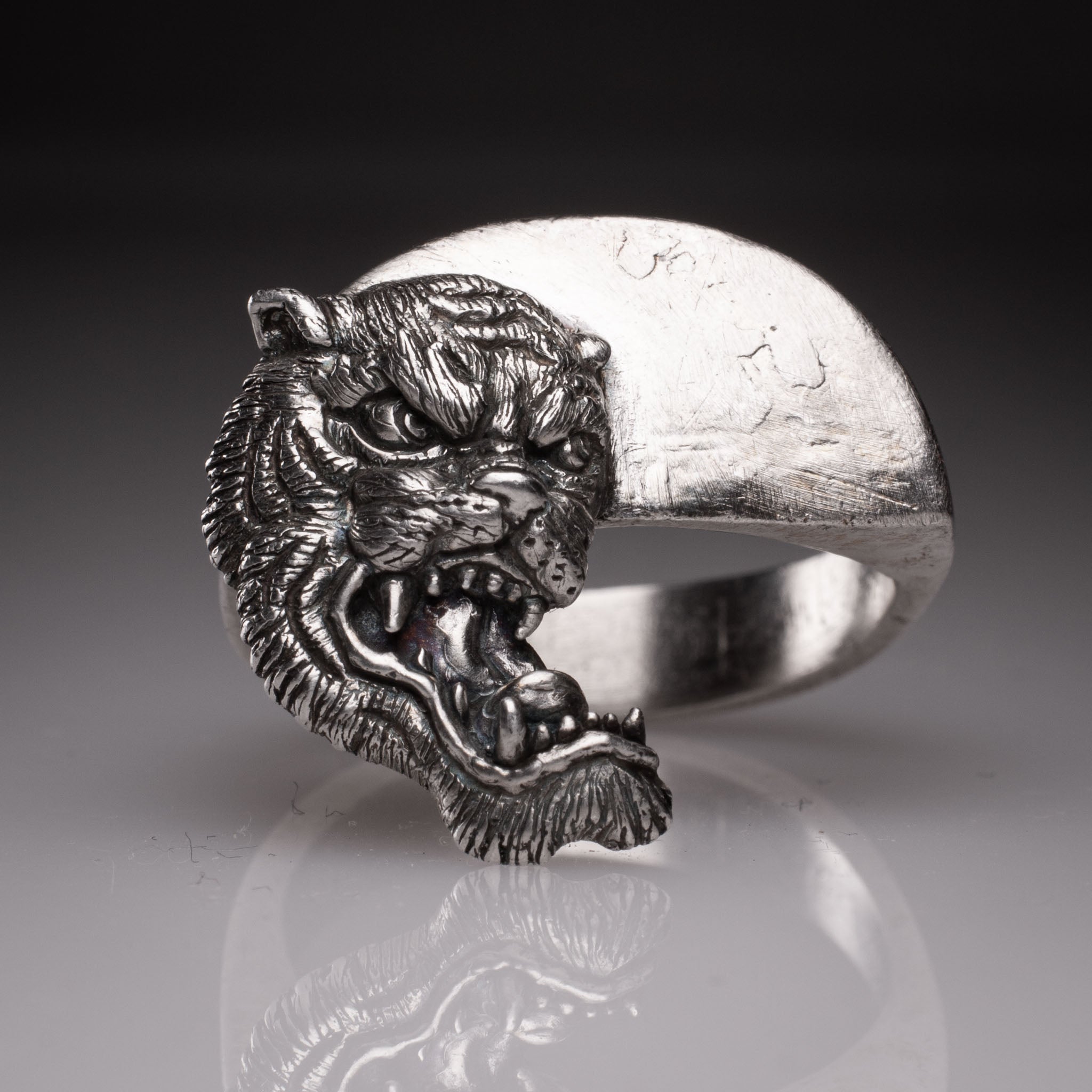 Two 925 silver rings forming a Yin Yang circle when joined, featuring detailed faces of a Dragon and a Tiger, handcrafted by KaijuLab.
