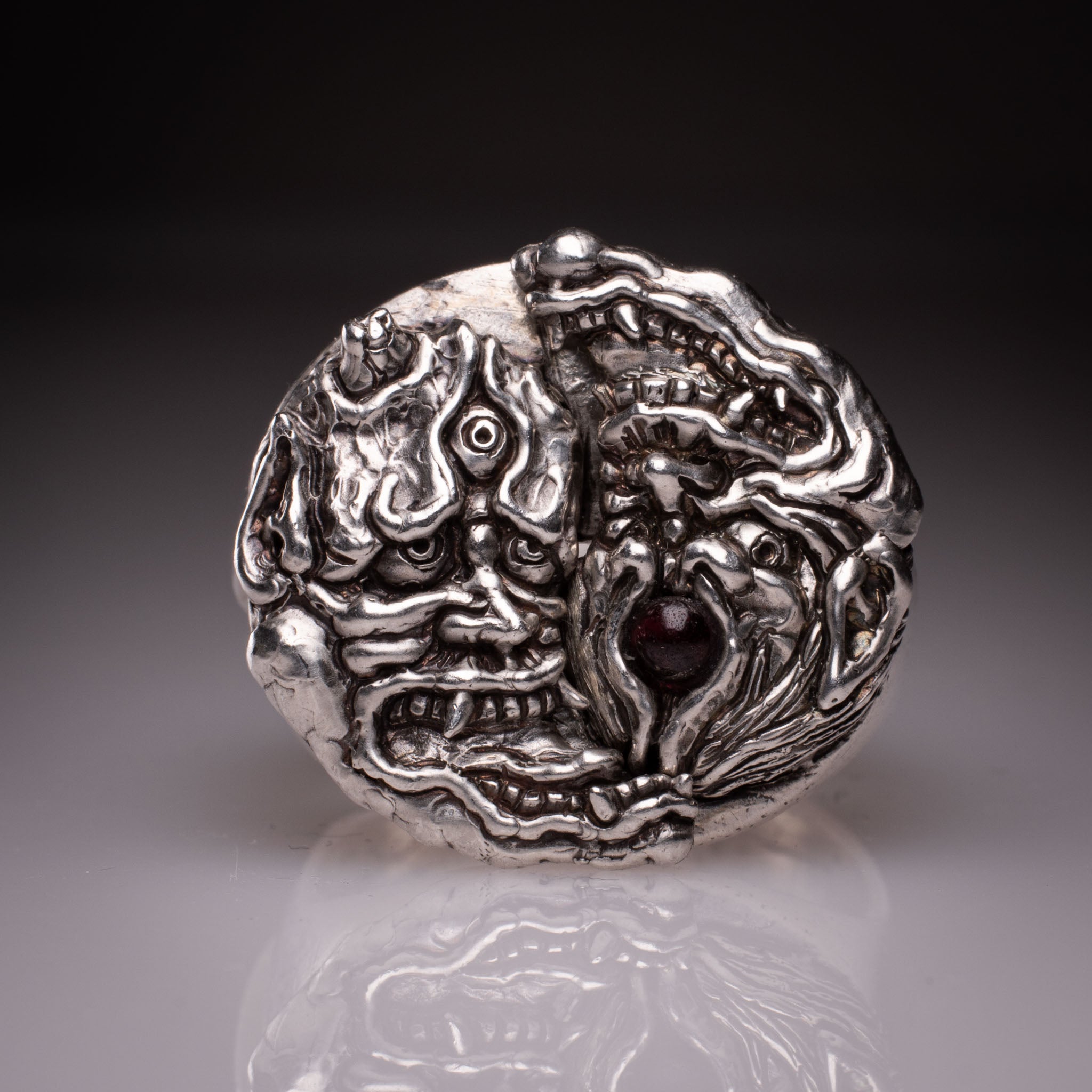 Two 925 silver rings forming a Hannya mask when joined, showing the Yin Yang interlocking design and red stone detail, handcrafted by KaijuLab.