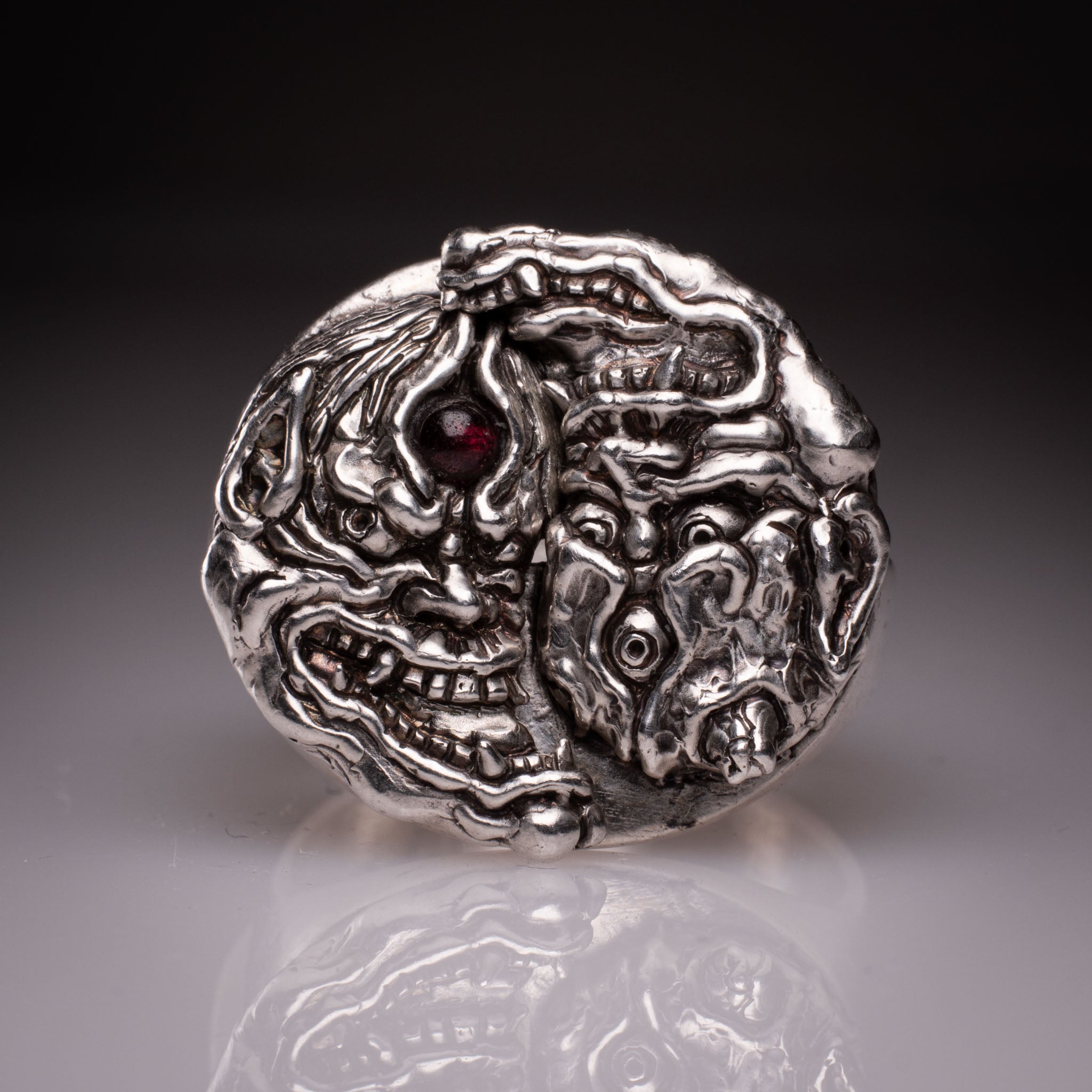 Two 925 silver rings forming a Hannya mask when joined, showing the Yin Yang interlocking design and red stone detail, handcrafted by KaijuLab.