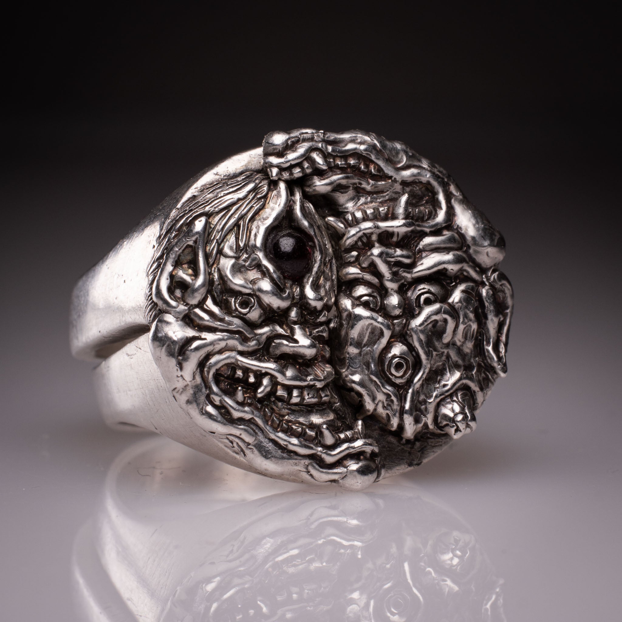 Two 925 silver rings forming a Hannya mask when joined, showing the Yin Yang interlocking design and red stone detail, handcrafted by KaijuLab.