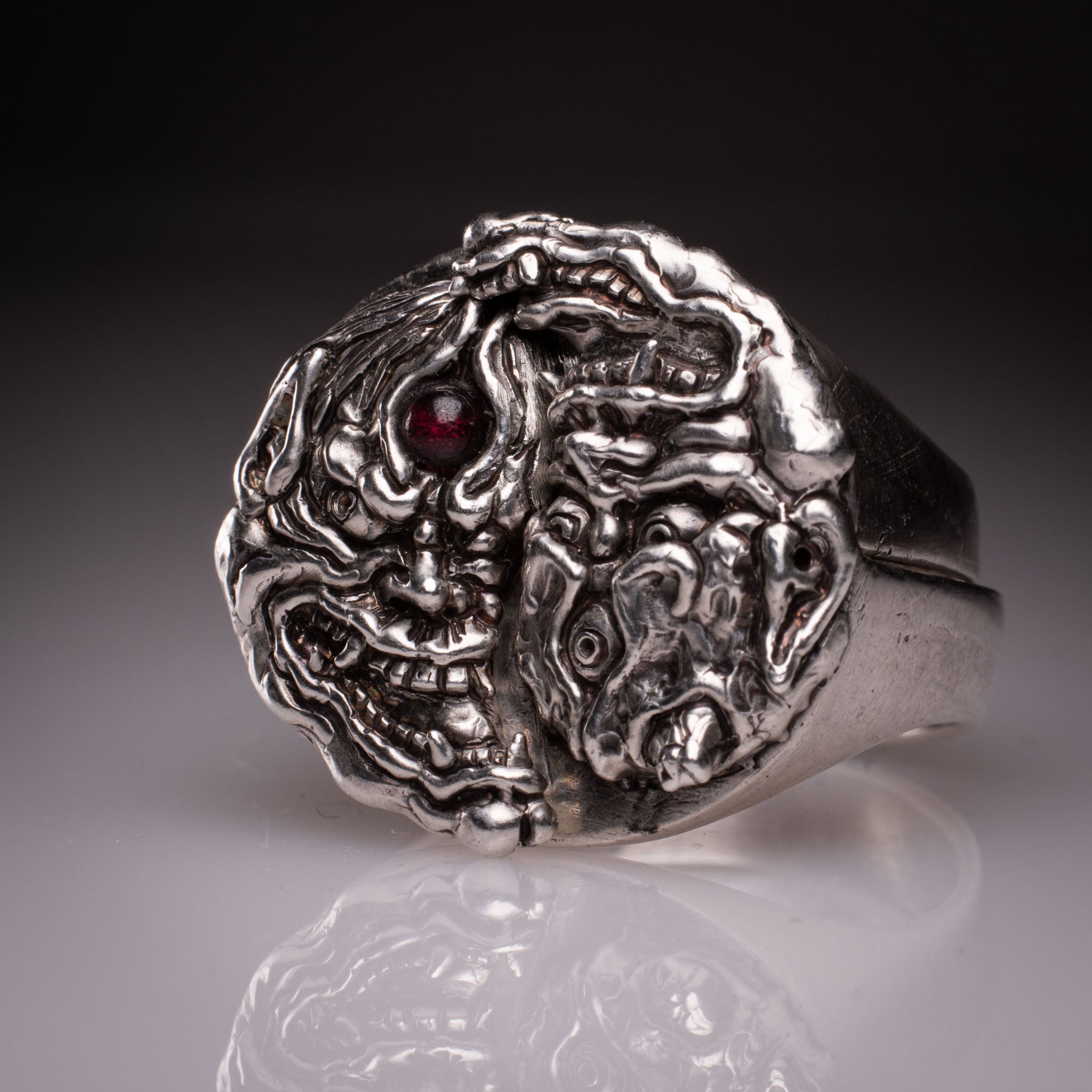 Two 925 silver rings forming a Hannya mask when joined, showing the Yin Yang interlocking design and red stone detail, handcrafted by KaijuLab.