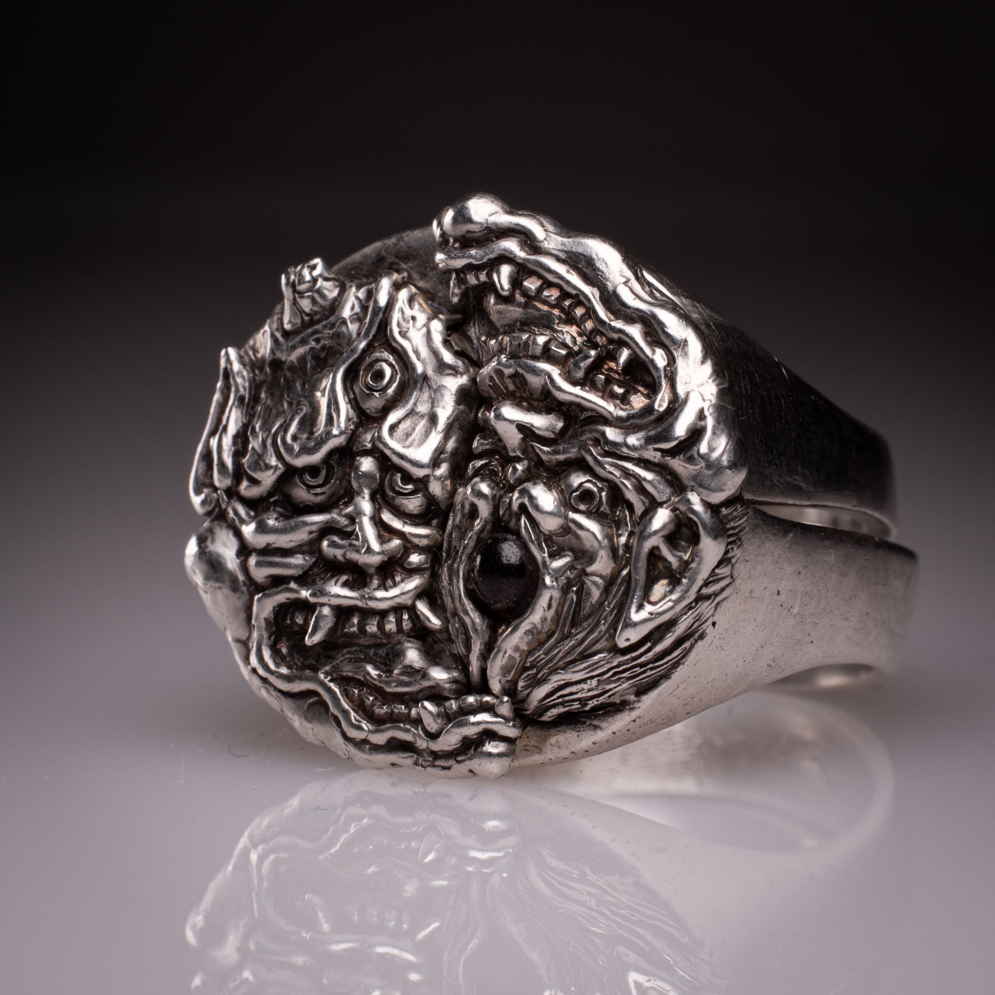 Two 925 silver rings forming a Hannya mask when joined, showing the Yin Yang interlocking design and red stone detail, handcrafted by KaijuLab.