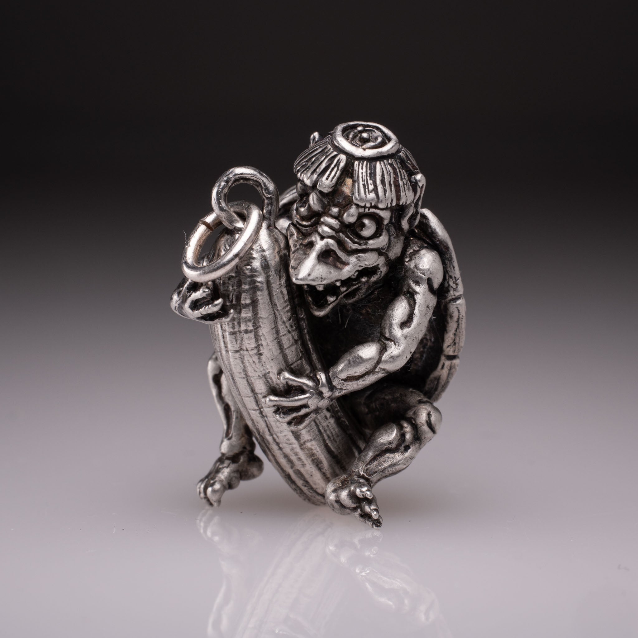 Handcrafted 925 silver full-body Kappa Yokai pendant hugging a cucumber, featuring detailed shell and tattoo art style by David Saez for KaijuLab.