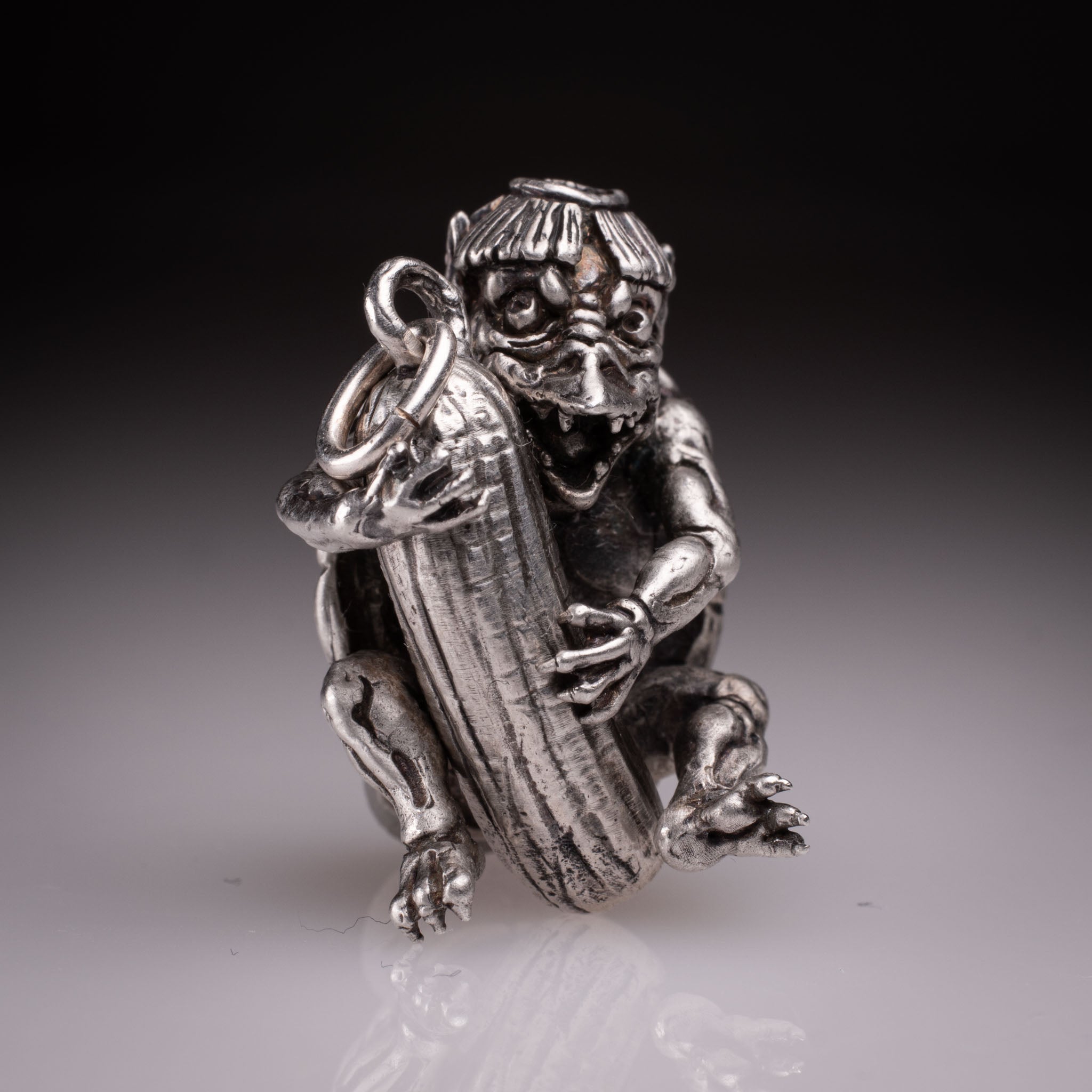 Handcrafted 925 silver full-body Kappa Yokai pendant hugging a cucumber, featuring detailed shell and tattoo art style by David Saez for KaijuLab.