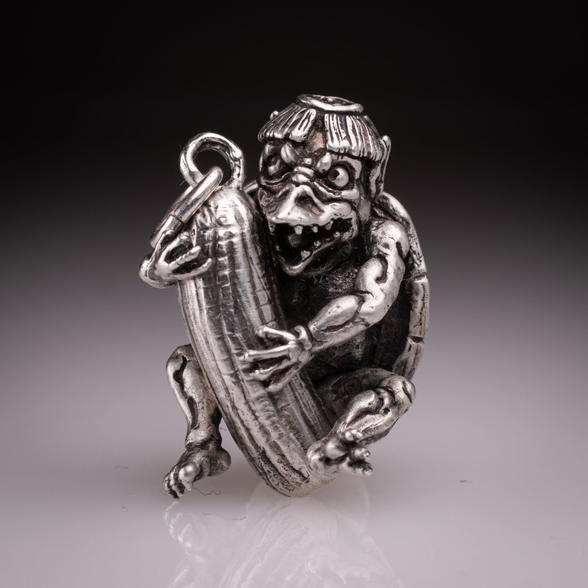 Handcrafted 925 silver full-body Kappa Yokai pendant hugging a cucumber, featuring detailed shell and tattoo art style by David Saez for KaijuLab.