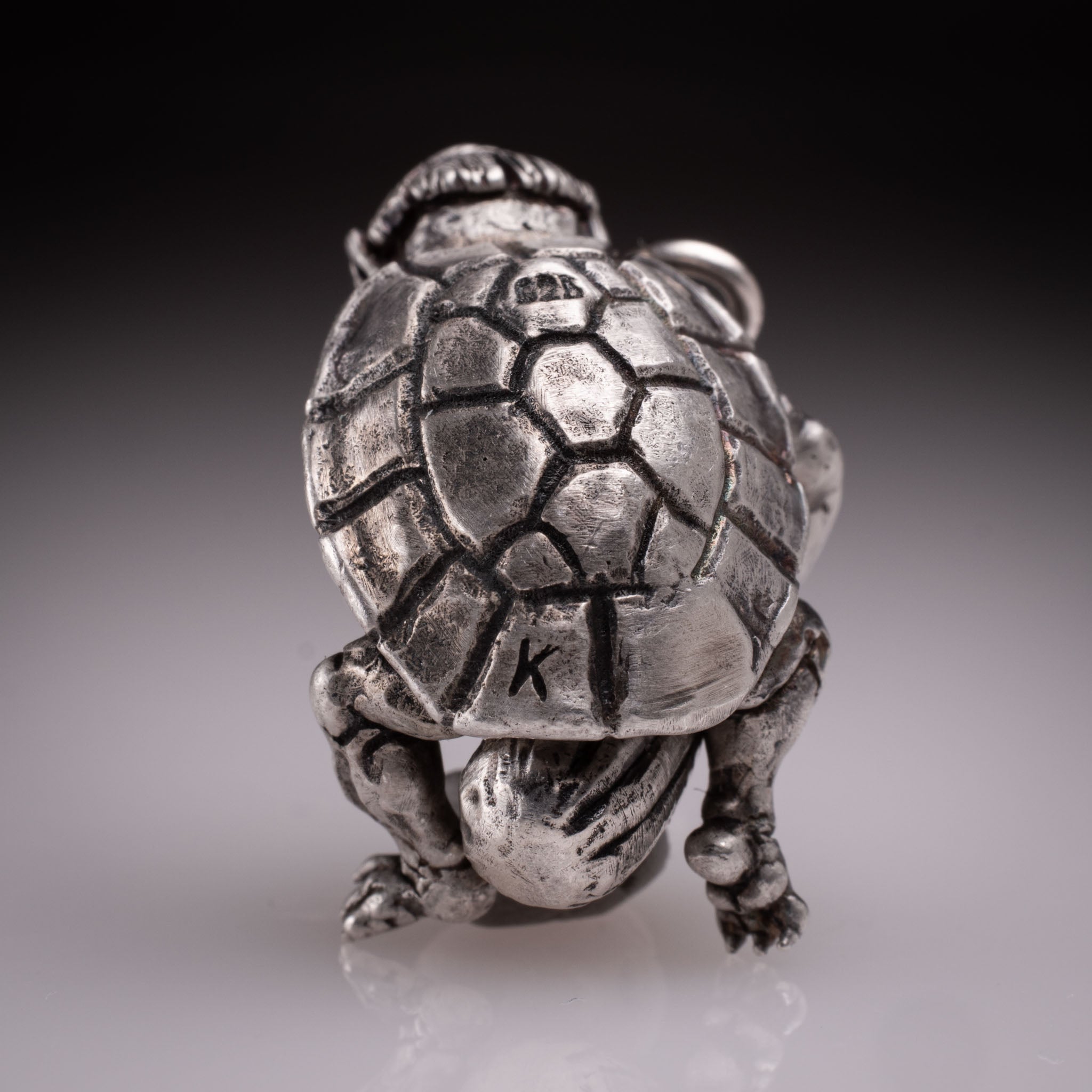 Handcrafted 925 silver full-body Kappa Yokai pendant hugging a cucumber, featuring detailed shell and tattoo art style by David Saez for KaijuLab.