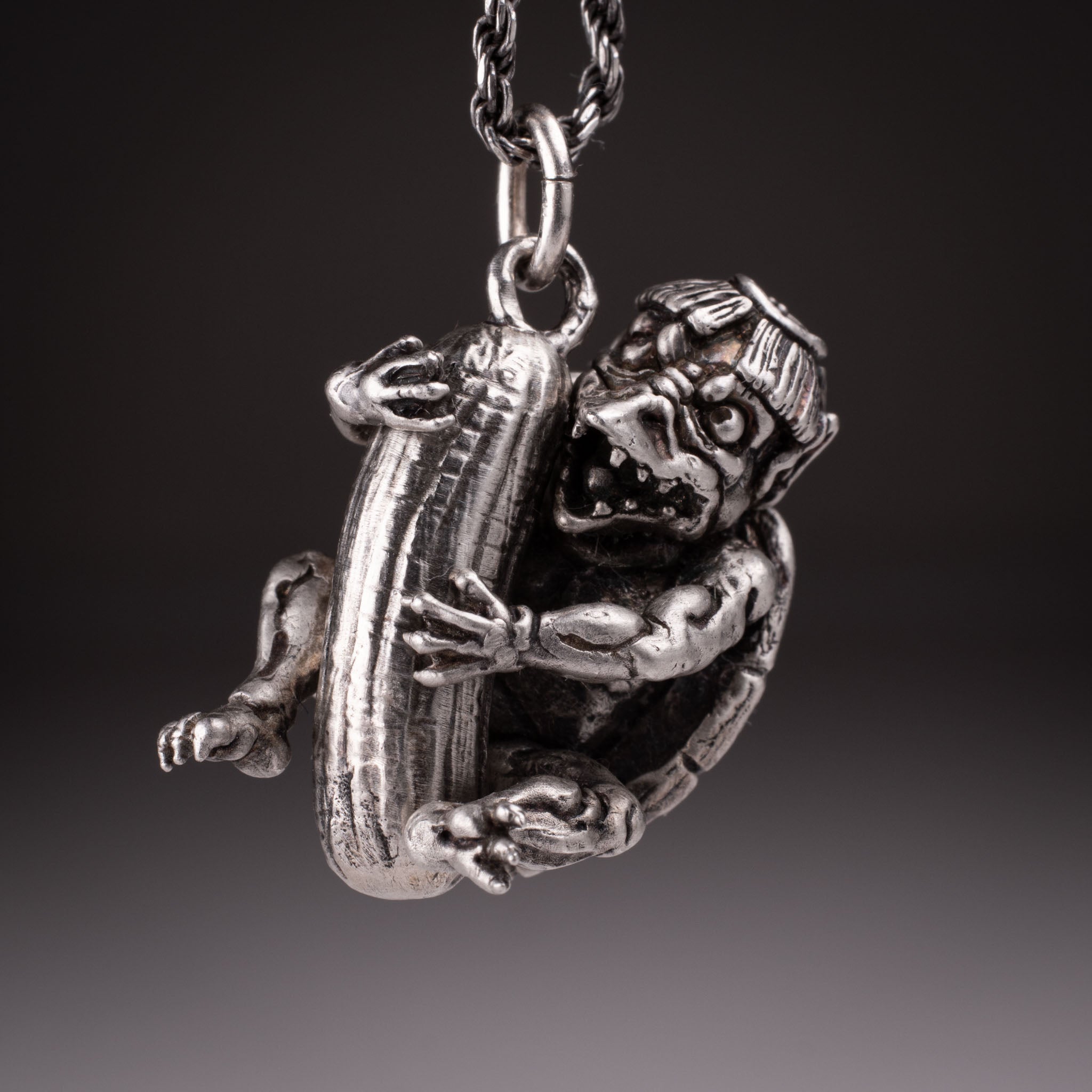 Handcrafted 925 silver full-body Kappa Yokai pendant hugging a cucumber, featuring detailed shell and tattoo art style by David Saez for KaijuLab.