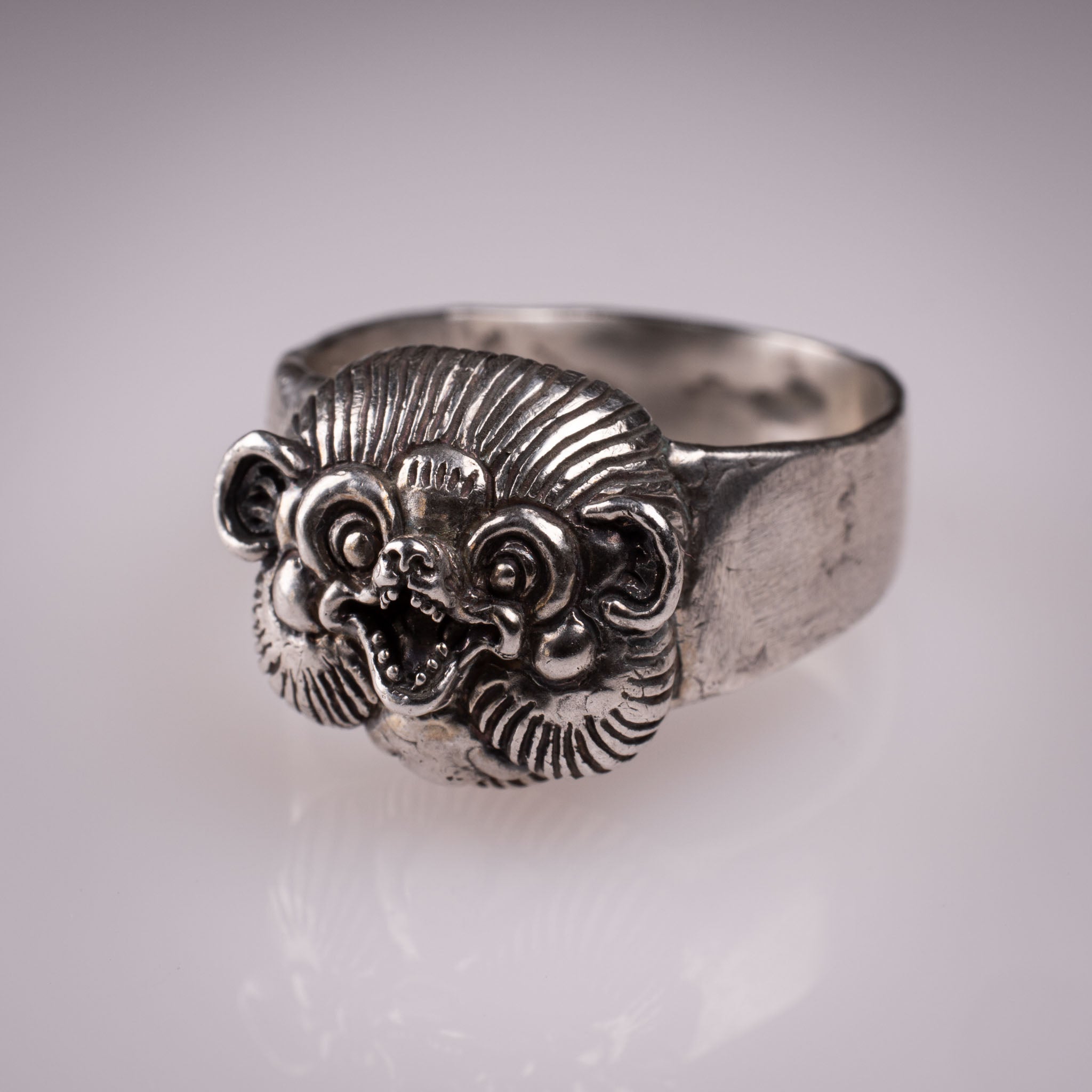 Handcrafted 925 silver Tanuki Mask Ring showing the intricate facial features and tattoo-inspired details designed by David Saez for KaijuLab.